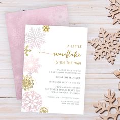 a little snowflake is on the way baby shower party invitation with pink and gold snowflakes