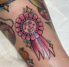 a woman's leg with a tattoo that says doing my best on it and a flower in the center