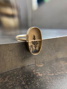 A tree-like dendritic agate is Captured in 14k gold. One-of-a-kind. Nature-inspired Oval Rings Untreated, Nature-inspired Untreated Oval Rings, Areas Of Life, Lone Tree, Dendritic Agate, Oval Ring, Oval Rings, Agate Ring, The Stone