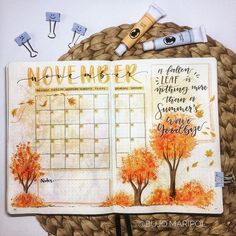 an open planner with fall trees and leaves on it