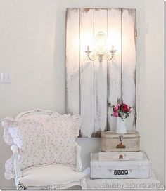 a white chair sitting next to a table with flowers on it