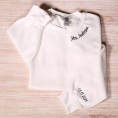 Personalized Mrs Embroidery Sweatshirt With Date On Sleeve, Custom Future Mrs Hoodie, Bridal Party Outfit, Engagement Gift, Bride To Be Gift Looking for a distinctive personalized sweatshirt? These embroidered sweatshirts offer a wonderful option for various occasions such as anniversaries, gifts for your significant other, or as a keepsake for a special milestone in your relationship. To Place Your Order: Begin by selecting your preferred sweatshirt color. Then, choose the size that fits you be Fitted Long Sleeve Top With Custom Embroidery, White Long Sleeve Sweatshirt With Letter Embroidery, White Long Sleeve Hoodie With Embroidered Text, Mrs Hoodie, Outfit Engagement, Mrs Sweatshirt, Bridal Party Outfit, Wedding Personalized, Wedding Party Gift