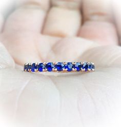 Full Eternity Band Ring with Natural Royal Blue Sapphires. MaterialSolid Gold (14K & 18K) or PLATINUM 950 FinishingHigh Polished/ Shiny PlatingOnly if WHITE GOLD - Rhodium/ Platinum Family FitComfort/ Rounded Width2.3 mm Height2 mm Setting TypePave StoneNatural Blue Sapphire QualityAAA Shape & CutRound, Diamond Cut Stone Size2 mm Quantity of Stones: apx 32 Click below to add laser engraving. https://www.etsy.com/listing/631070916/laser-engraving?ga_search_query=laser%2Bengraving&ref= Pink Sapphire Wedding Band, Blue Sapphire Eternity Band, Blue Sapphire Wedding Band, Gold Wrap Ring, Sapphire Eternity Band, Sapphire Eternity Ring, Sapphire Wedding Band, Black Wedding Rings, Sapphire Band