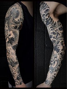 a man's arm covered in black and grey ink with dragon tattoos on it