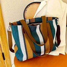 Brand New Never Used Teal, Gold And White. Colorful Striped Summer Cross Body/ Shoulder Bag Attractive, Lightweight Weave Design Third Picture From The Top Is For Size Reference Only And It's Not The Color Of The Bag. Versatile Summer And Shopper Bag Size: 11" X 14" X 4" Approximately All Offers Are Welcome And Thank You For Stopping By My Closet! If You Have Any Questions Please Leave Them In The Comment Field. Thanks Multicolor Shoulder Bag With Adjustable Handle For On-the-go, Blue Top Handle Bucket Bag With Large Capacity, Blue Canvas Shoulder Bag With Handles, Blue Large Capacity Satchel Bag, Blue Bags With Large Capacity And Double Handle, Large Capacity Blue Bags With Double Handle, Blue Handheld Shoulder Bag For Travel, Blue Tote Bag With Top Carry Handle, Blue Satchel Shoulder Bag With Large Capacity