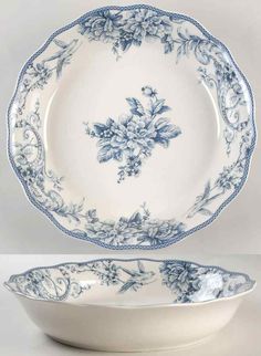 a blue and white plate with an ornate design on the rim, next to a bowl