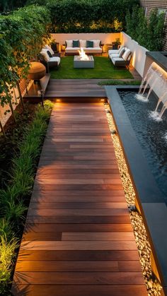 an outdoor patio with wooden flooring and water feature in the center, surrounded by greenery