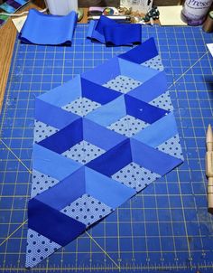 a blue cutting mat with some scissors on top of it and another piece of fabric next to it