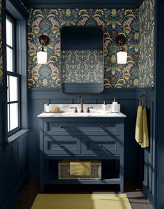 a bathroom with green walls and blue vanity