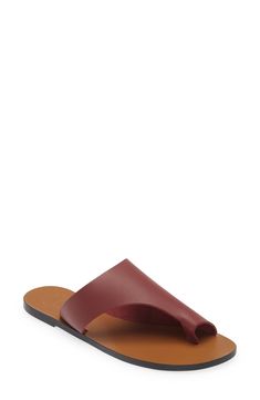 A cutout strap and sleek toe loop make this leather sandal a casual style standout. Leather upper, lining and sole Made in Italy Modern Toe Loop Sandals With Removable Insole, Modern Slides With Single Toe Strap And Leather Footbed, Modern Slides With Leather Footbed And Single Toe Strap, Modern Leather Slides With Single Toe Strap, Chic Leather Slides With Single Toe Strap, Chic Mules With Leather Lining And Single Toe Strap, Chic Leather Toe Ring Sandals With Removable Insole, Leather Toe Loop Slides For Spring, Spring Leather Toe Loop Mules