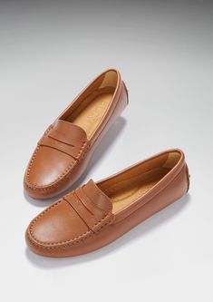 Hugs & Co. tan leather penny loafer driving shoes for women. Moccasin style driving loafers in luxurious tan outer and lined with a soft leather for extra comfort. Made in Portugal 100% leather upper featuring a 100% leather Lining rubber studded sole