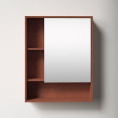 an empty wooden shelf with a mirror on it