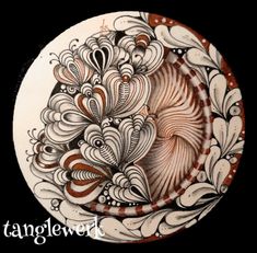 a white and brown plate with an intricate design on the front, sitting on a black background