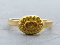 "One of a kind gold ring with Citrine. The raw yellow Citrine wrapped and decorated with 22k gold over rustic oval top made of 22k solid gold. The delicate band made of 14k solid gold, slightly hammered. Ring size : 7 3/4 (US size) - can enlarge the ring up to 8. Top ring dimension : 0.4/0.3\" (10/8 mm). 14k gold band width : 0.08\" (2 mm). The ring will be packed in a gift box ready to be given as a gift, and will be shipped via express mail service that usually takes 5-10 days to arrive. ▶ Vie Gold Oval Yellow Sapphire Ring, Oval Yellow Sapphire Ring In Gold, 22k Yellow Gold Emerald Ring, Gold Yellow Sapphire Ring Gift, Gold Yellow Sapphire Birthstone Ring, Gold Hallmarked Yellow Sapphire Rings, Gold Citrine Solitaire Ring, 22k Yellow Gold Ring With Bezel Setting, Gold Emerald Ring With Bezel Setting In Oval Shape