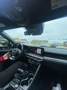 a woman is driving her car on the highway