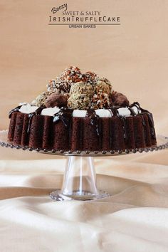 there is a chocolate cake with white frosting and toppings