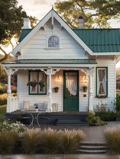 a white house with green shutters and windows