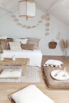 a living room filled with lots of furniture and decor on top of a hard wood floor