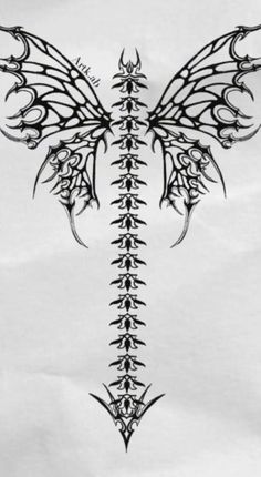 the back side of a tattoo design with an intricate butterfly wing and crossbones