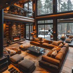 a living room filled with lots of furniture and a fire place in front of a large window