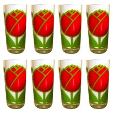 six shot glasses with red and green designs on them