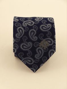 "Mens 100% silk blue paisley necktie. This Blue paisley tie features a navy background with blue ourlined with off white paisley pattern. Handmade from 100% silk, this special collection features a .75\" Eds Neckties logo at the bottom right front corner of every tie and a larger logo located on the tipping (Back of the tie). The label features the collection name (Nathaniel Alexandria) Named after my son Nathaniel and my daughter Alexandria. Expertly hand-made from 100% silk you can select your Blue Paisley Print Ties For Business, Blue Paisley Print Business Ties, Blue Paisley Print Suit And Tie Accessories, Blue Paisley Print Tie For Black Tie Events, Blue Paisley Print Ties For Black Tie Events, Blue Paisley Print Ties For Black Tie Occasion, Blue Paisley Print Standard Tie, Blue Paisley Print Tie, Purple Gothic