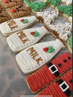 decorated cookies are arranged on a table with words that read happy new year and christmas trees