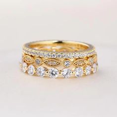 a stack of gold and white diamond rings