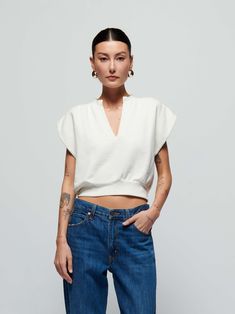 When casual meets chic, you get this sweatshirt top with a daring notch neckline, breezy cap sleeves, and a semi cropped silhouette. (This one comes in Porcelain.) Wear it with the Lincoln Pant. | Lenon Top in Porcelain | Ethical Essentials Relaxed Fit V-neck Top For Casual Gatherings, Chic Slightly Cropped Top For Fall, White V-neck Top For Casual Gatherings, Effortless White Top For Casual Gatherings, Chic Slightly Cropped White Top, Versatile V-neck Top For Casual Gatherings, Versatile Cropped Tops With Relaxed Fit, Relaxed Fit V-neck Crop Top, Chic Cropped Relaxed Fit Tops