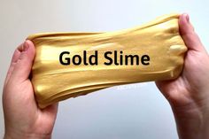 someone holding up a gold slime bar with the word'gold slime'printed on it