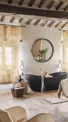 a bathroom with an oval mirror above the bathtub