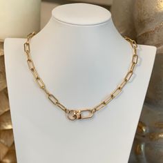 Introducing the Lennox Necklace - a versatile and stylish piece of jewelry that is perfect for any occasion. This link necklace features an alluring buckle clasp detail that can be worn at the front for a dressy look or at the back for a more casual one. Its versatility makes it great for layering with other necklaces, allowing you to create a unique and personalized look that is all your own. Crafted from high-quality materials, the Lennox Necklace features an 18k gold plating that gives it a l Modern Gold-tone Oval Link Necklaces, Yellow Gold Tarnish-resistant Oval Link Necklace, Tarnish Resistant Gold-tone Link Necklace, Luxury Gold-tone Oval Link Necklace, Gold-tone Brass Chain Link Necklace, Link Necklace, Gold Plating, Layering, 18k Gold