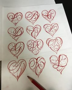 some hearts are drawn on paper with a pen