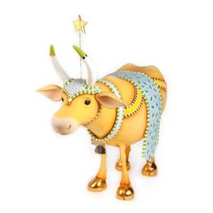 a yellow bull figurine with horns and stars on it's head, holding a star