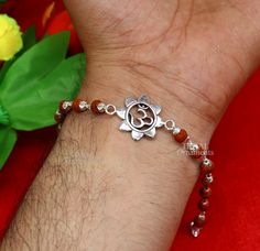 This amazing silver Rakhi crafted from 925 silver with immense precision. It exudes excellent craftsmanship and will surely look wonderful on your brother's wrist. handmade custom design Aum or OM Bracelet Or Rakhi bracelet this is special design beaded bracelet we can use either Rakhi bracelet or daily use bracelet for unisex. Best Rakshabandhan wishes sibling gift for your brother and sister's , buyer can be select bracelet style from option we have Rudraksh, black basil rosary, white rosary a Rudraksh Rakhi Design, Fusion Style Sterling Silver Beaded Bracelets As Gift, Sterling Silver Fusion Beaded Bracelets As Gift, Sterling Silver Fusion Beaded Bracelets For Gifts, Symbolic Sterling Silver Bracelets For Festivals, Silver Round Beads Jewelry For Puja, Symbolic Silver Bracelets With 8mm Beads, Sterling Silver Bracelets For Festivals, Sterling Silver Bracelets With Silver Beads For Festive Occasions