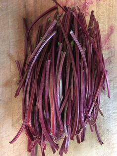 purple beans are laid out on a cutting board