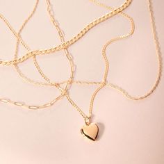 Four gold chains are draped on a pink background. One has a heart locket charm strung onto it. Catbird Jewelry, Cuban Chain, Recycled Gold, Night Looks, Engagement Ring Wedding Band, Gifts For Wedding Party, Wedding Ring Bands, True Love, Gold Chain