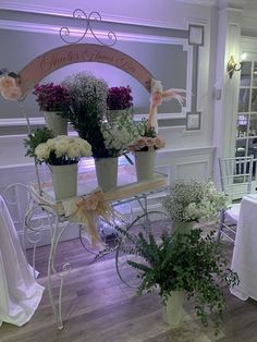 flowers are arranged in buckets on a carriage for a wedding reception at the hotel