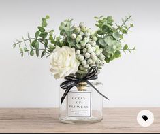 a vase filled with flowers on top of a wooden table