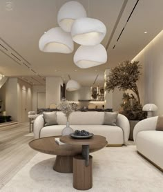 a living room filled with white furniture and lots of lights