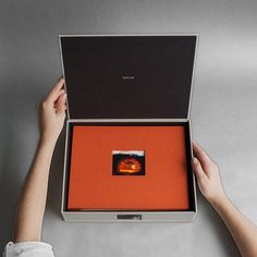 a person holding an open box with something in it that looks like a fireball