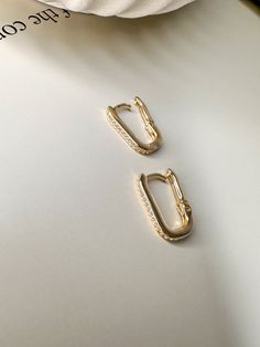 The Velani Rectangle Clicker Earrings are stunning and high-quality. They feature a polished or CZ finish. This piece will make you feel beautiful and will pair perfectly with any outfit. Hypoallergenic and Nickel Free Size: 15mm x 10mm Water Resistant Made in Brazil 18K Gold Filled Add a modern twist to your jewelry collection with the Velani Rectangle Clicker Earrings. These stylish earrings feature a sleek rectangular design, perfect for adding a touch of contemporary elegance to any outfit. Everyday Rectangular Nickel-free Earrings, Minimalist Rectangular Hoop Earrings, Tarnish Resistant, Minimalist 14k Gold Rectangular Earrings, Gold Rectangular Cubic Zirconia Earrings, Gold Rectangular Clip-on Earrings, Sale Store, Stylish Earring, Waterproof Jewelry, Anklet Bracelet