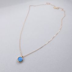 "\"Blue Opal Necklace | Opal Gemstone Pendant | Minimal and Elegant Gold Necklace for Daily Use | Anniversary Valentine Gift | Gift for Her\" In the Middle Ages, opal was considered a stone that could provide great luck because it was believed to possess all the virtues of each gemstone whose color was represented in the color spectrum of the opal. It was also said to grant invisibility if wrapped in a fresh bay leaf and held in the hand. This minimal necklace is a perfect minimal gift for your Blue Birthstone Necklace As Gift For Her, Dainty Blue Necklace For Her, Delicate Blue Birthstone Jewelry, Minimalist Opal Pendant Jewelry, Blue Birthstone Dainty Jewelry, Blue Dainty Birthstone Jewelry, Elegant Opal Clavicle Chain Jewelry, Dainty Blue Birthstone Jewelry, Elegant Blue Jewelry With Bezel Setting