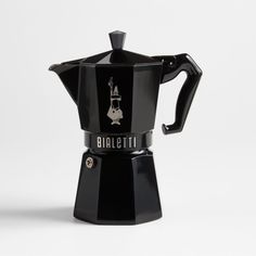 a black stove top coffee maker with the word bialetti on it