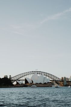 the sydney opera house and harbour bridge as seen from across the water