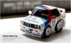 a toy bmw race car sitting on top of a table