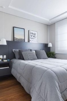 a bedroom with a bed, nightstands and pictures on the wall