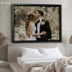 a couple kissing on their wedding day in front of a wall with the words love