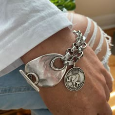 Awesome chunky bracelet decorated with antique toggle clasp and elephant charm.  Made of a mixt of bright silver rolo and cable chain with antique silver clasp and charm, you'll be charmed by the stylish look of this bracelet. The chains are innoriginal and platinum silver plated stainless steel. The toggle clasp and elephant charm are in antique silver Zamak (real 925 antique silver plated pewter).  On picture, 6.5 inches wrist showing the 8 inches bracelet. Add approximately 1.25 - 1.5 inch (37mm) to your wrist size. You will receive this beautiful bracelet in a box decorated with bow. Thank you for visiting! Chunky Silver Bracelets, Chunky Silver Jewelry, Top Jewelry Trends, Chunky Silver Jewellery, Chunky Silver Bracelet, Chunky Charm Bracelet, Silver Bracelet For Women, Unique Silver Rings, Junk Jewelry