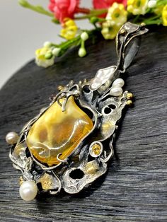 "ARTISAN AMBER PENDANT Hand-made Sterling Silver 925, 24 K Gold Stones used: Amber, Pearls, Garnet, Citrine, Mystic Topaz. Height - 75mm, Width - 45mm. Unique Handcrafted One-of a-kind Design Pendant Each Piece of Jewelry in my Collection is Absolutely One of a Kind! When you start wearing a piece of my jewelry you will fall in love with it more and more each day and feel that good Energy and Love that I pass into it while creating this piece of Art. A piece of Art created for you to be inspired Luxury Jewelry With Unique Design For Wedding, Luxury One-of-a-kind Jewelry For Weddings, Luxury Yellow Jewelry With Intricate Design, Exquisite Handmade Jewelry For Celebrations, Elegant One-of-a-kind Wedding Jewelry, Artisan Jewelry With Unique Design For Wedding, Artisan Wedding Jewelry With Unique Design, Luxury Wedding Jewelry With Unique Variations, One Of A Kind Luxury Jewelry For Wedding